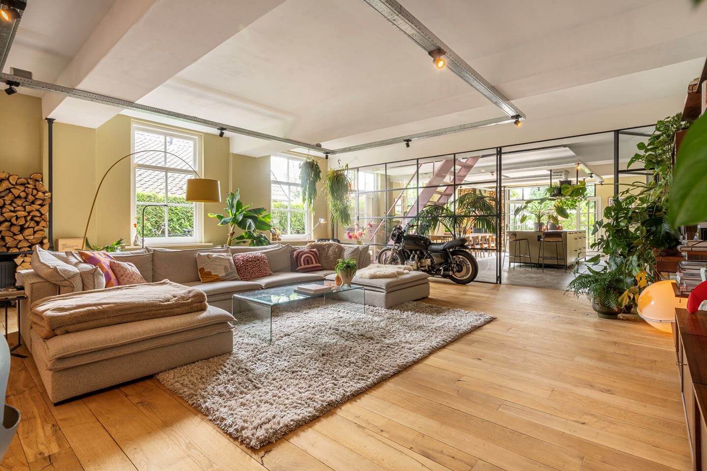 An Old Smokehouse Transformed Into a Modern Industrial Home 2 living room with industrial glass wall