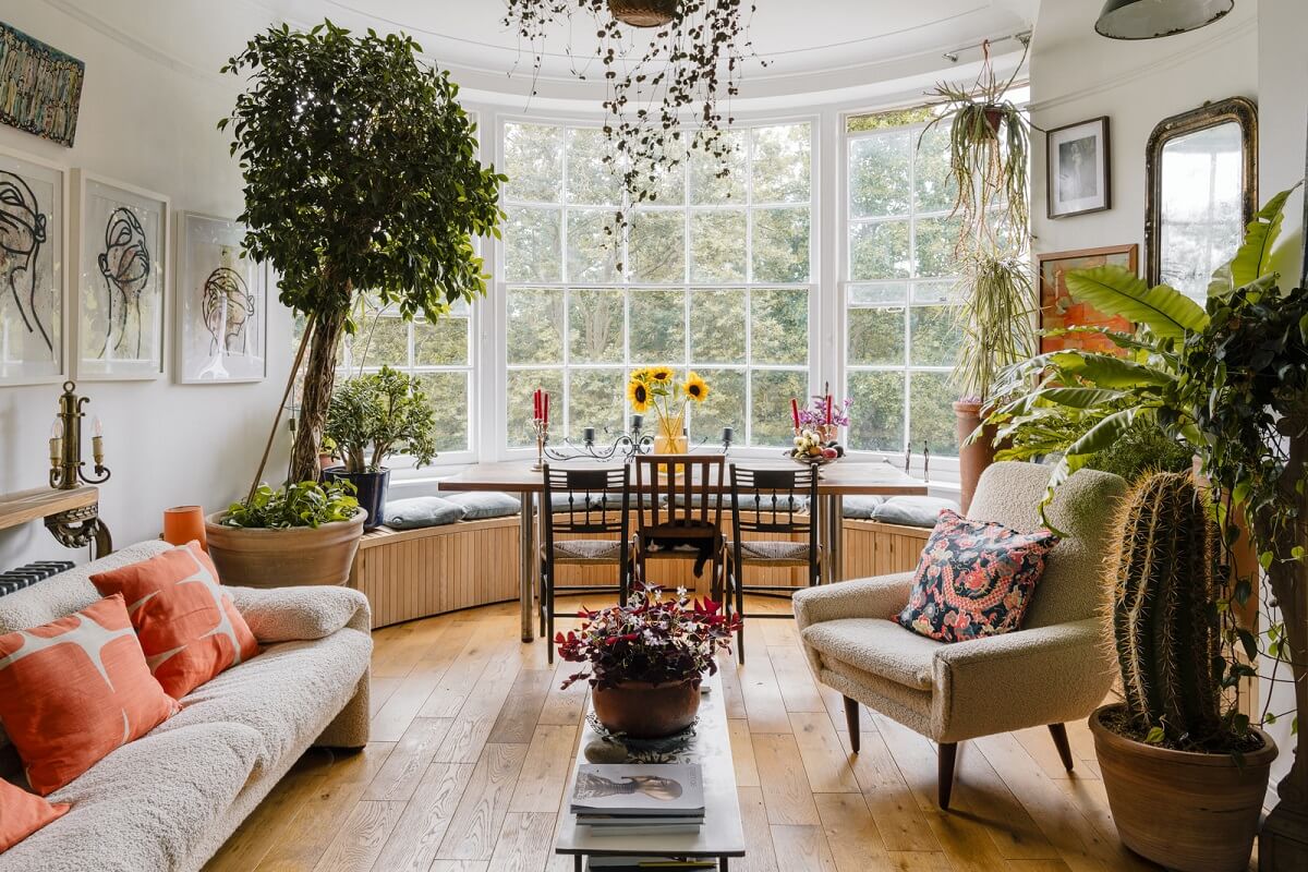 Plants, Art, and a Huge Bay Window in a London Apartment 2 living room with large bay window and plants nordroom