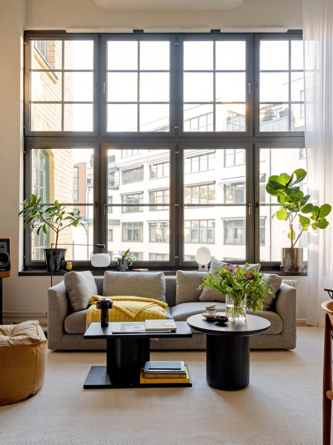 A Monochrome Loft with High Ceilings and Art 3 living room with large windows