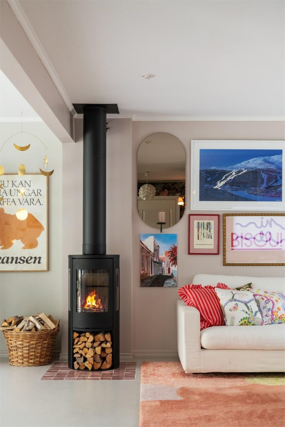A Bright Open-Plan Swedish Home with a Pink Kitchen 6 living room with peach rug and wood burner