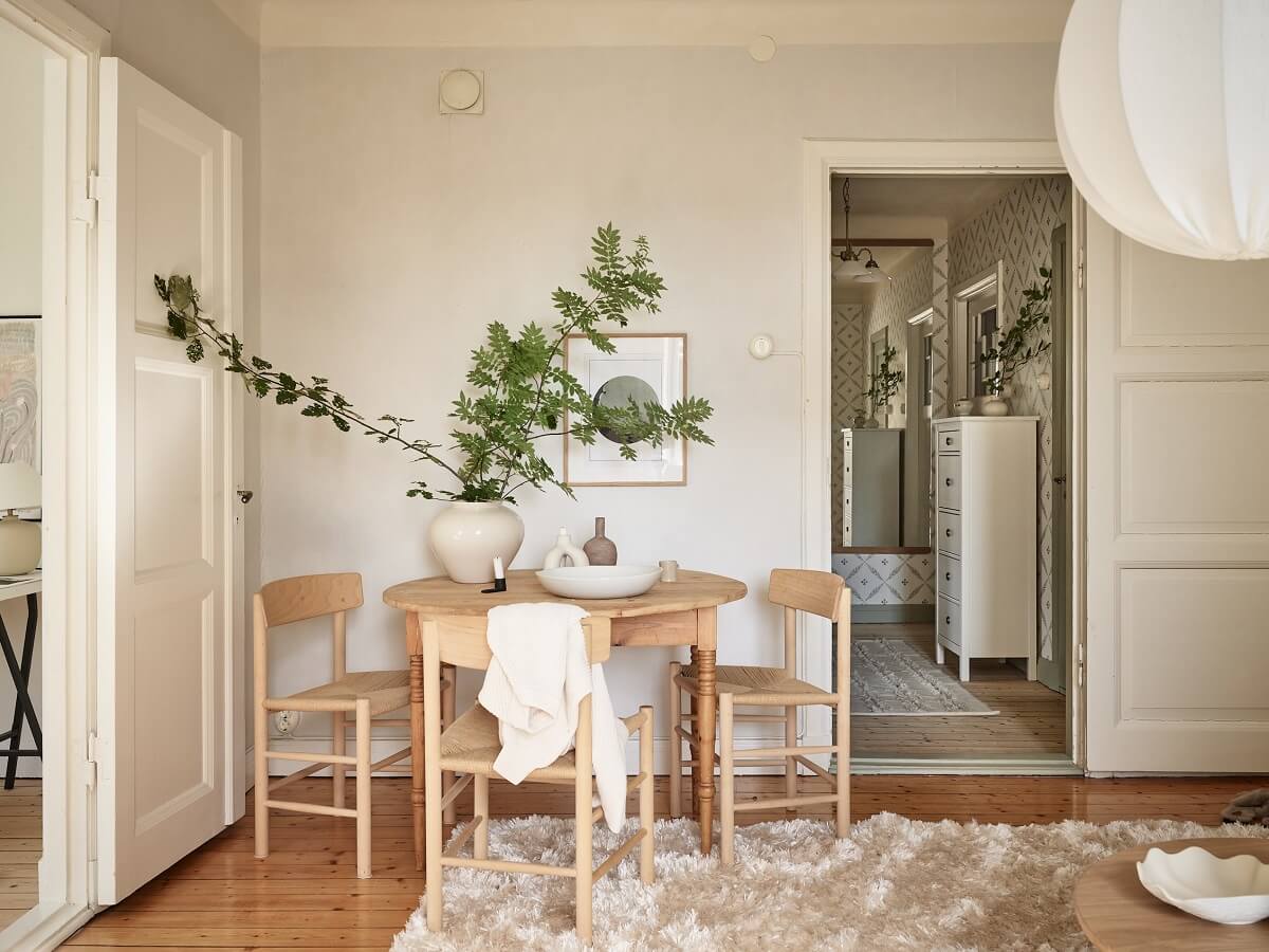 A Light Swedish Apartment with a Charming Kitchen 3 living room with round wooden table