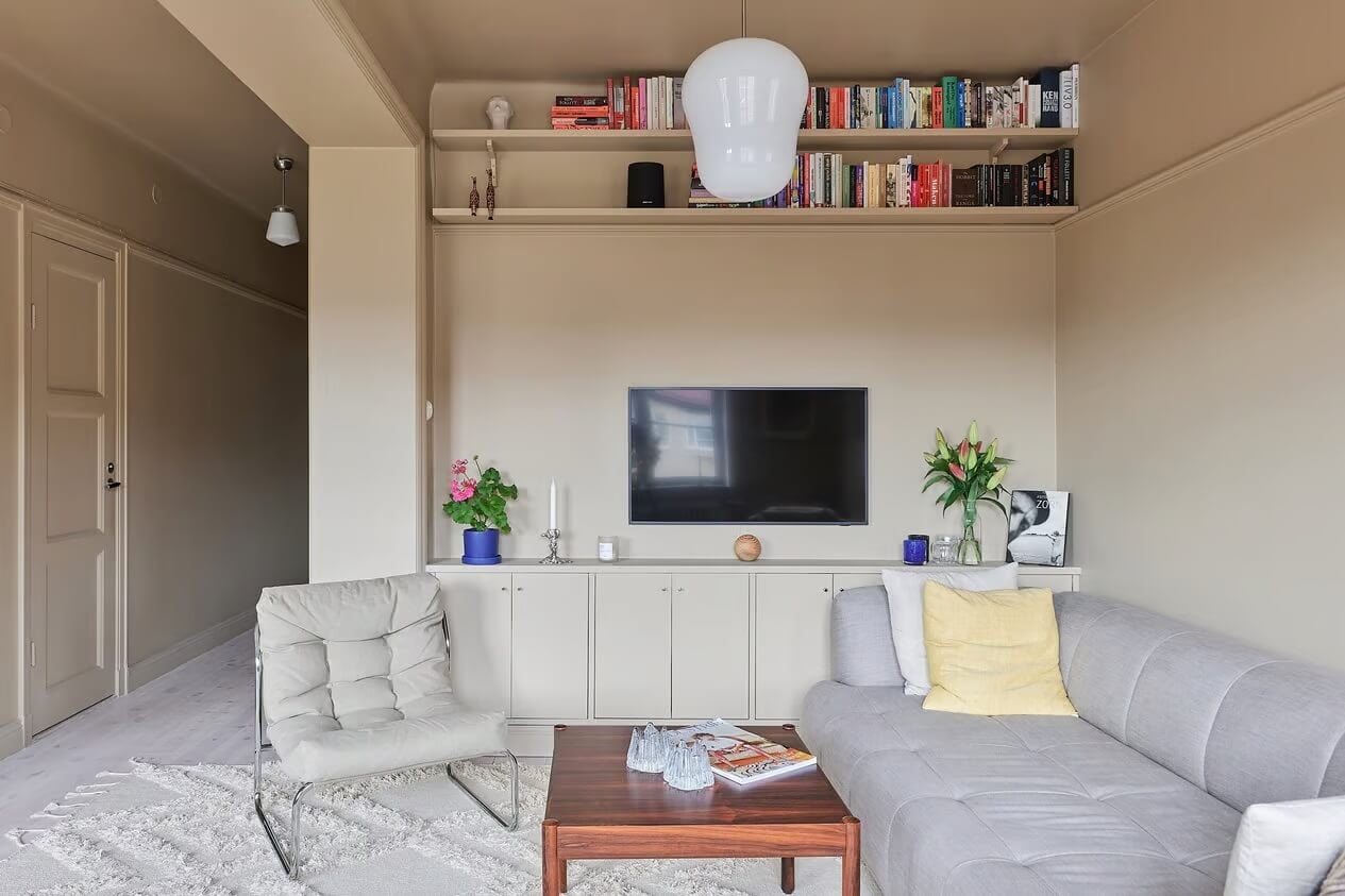 Warm Color-Drenched Rooms in a Swedish Apartment 4 living room with storage cabinets and shelves
