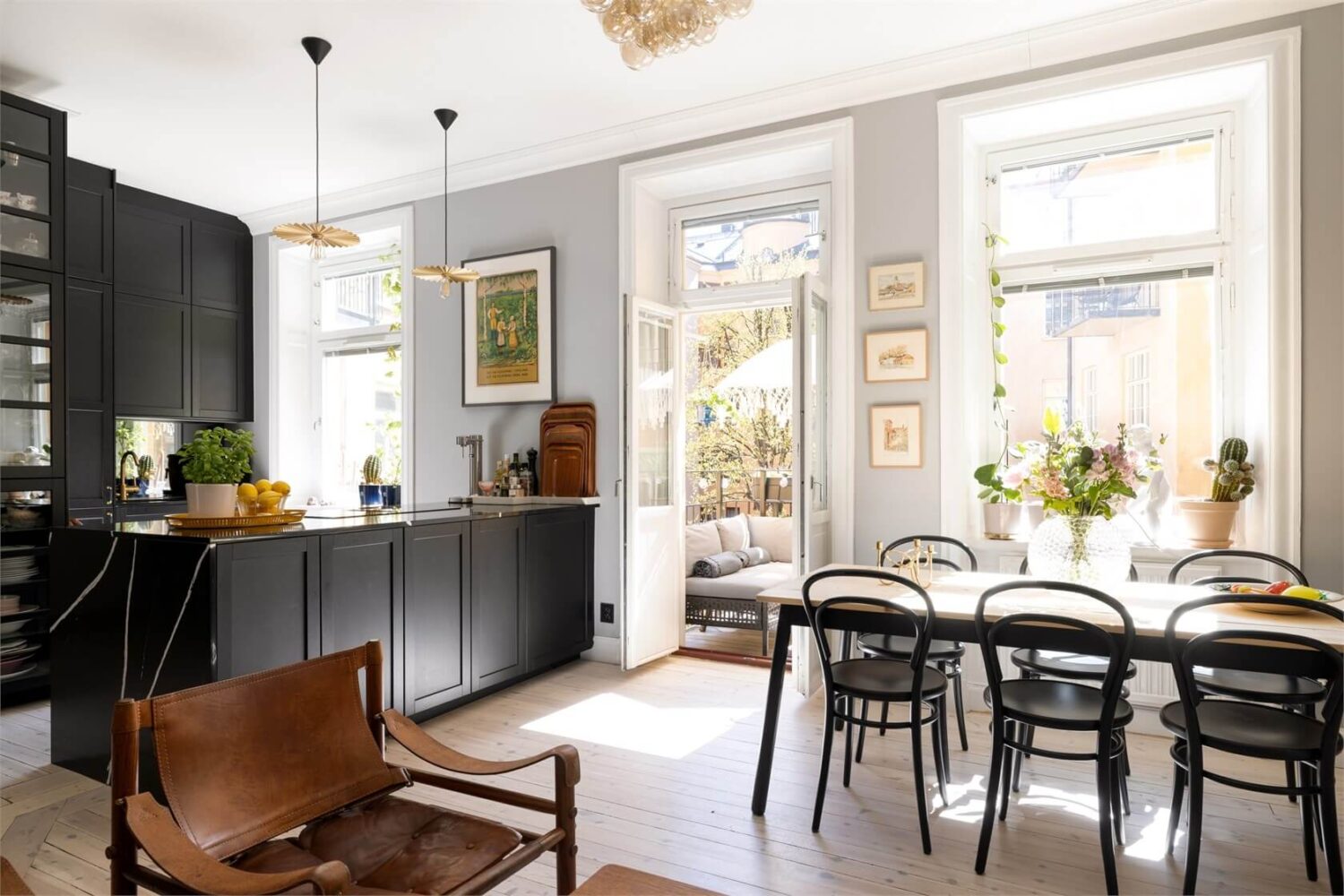 A Lovely Stockholm Apartment with a Black Kitchen and Pink Bedroom 12 living space with black kitchen and dining table
