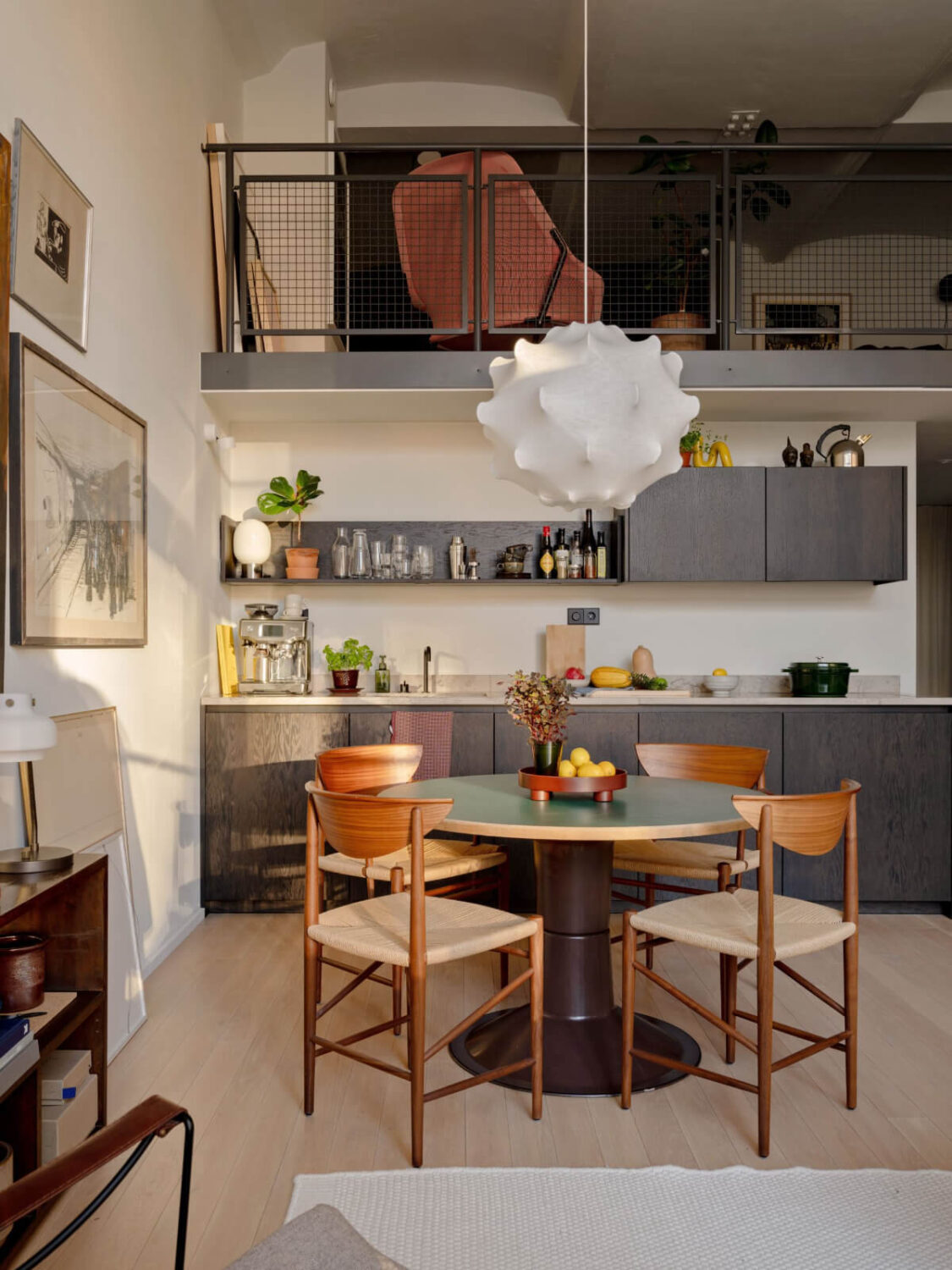 A Monochrome Loft with High Ceilings and Art 27 loft kitchen dark cabinets round table