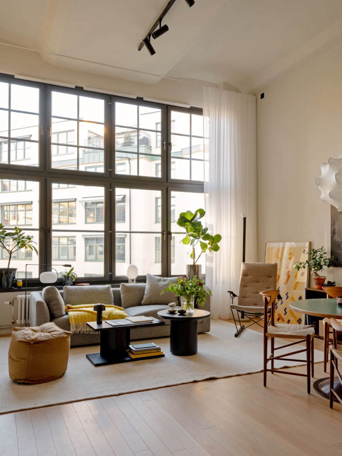 A Monochrome Loft with High Ceilings and Art 8 loft living room large windows wooden floor