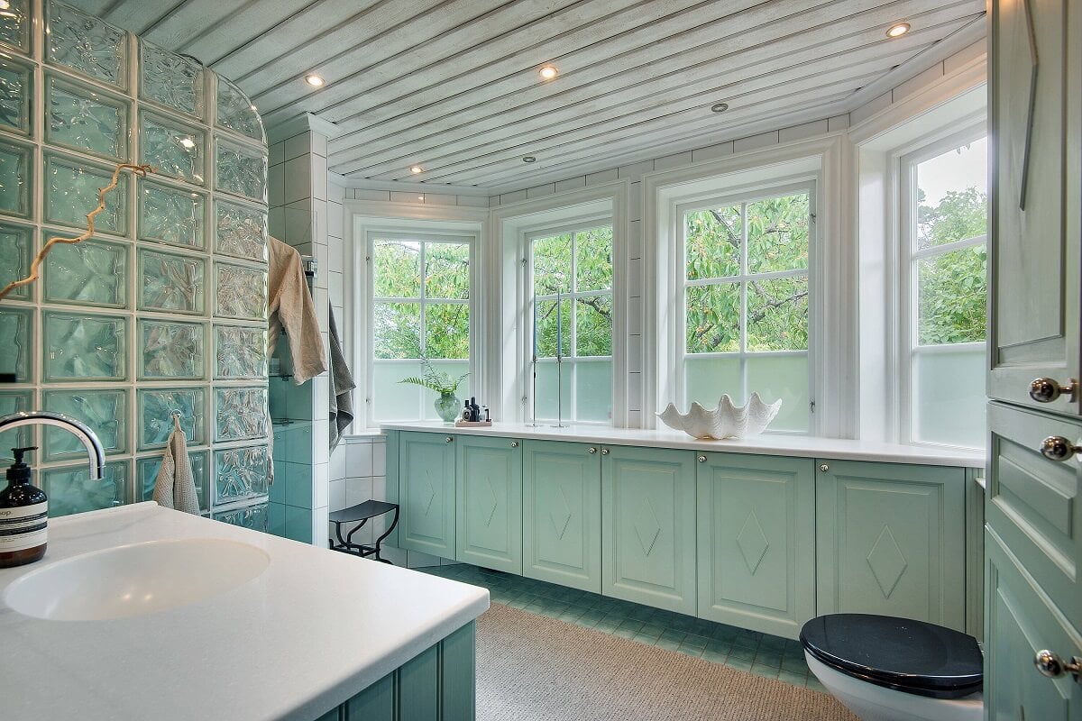 A Yellow Swedish Villa with Views of the Sea 16 mint green bathroom