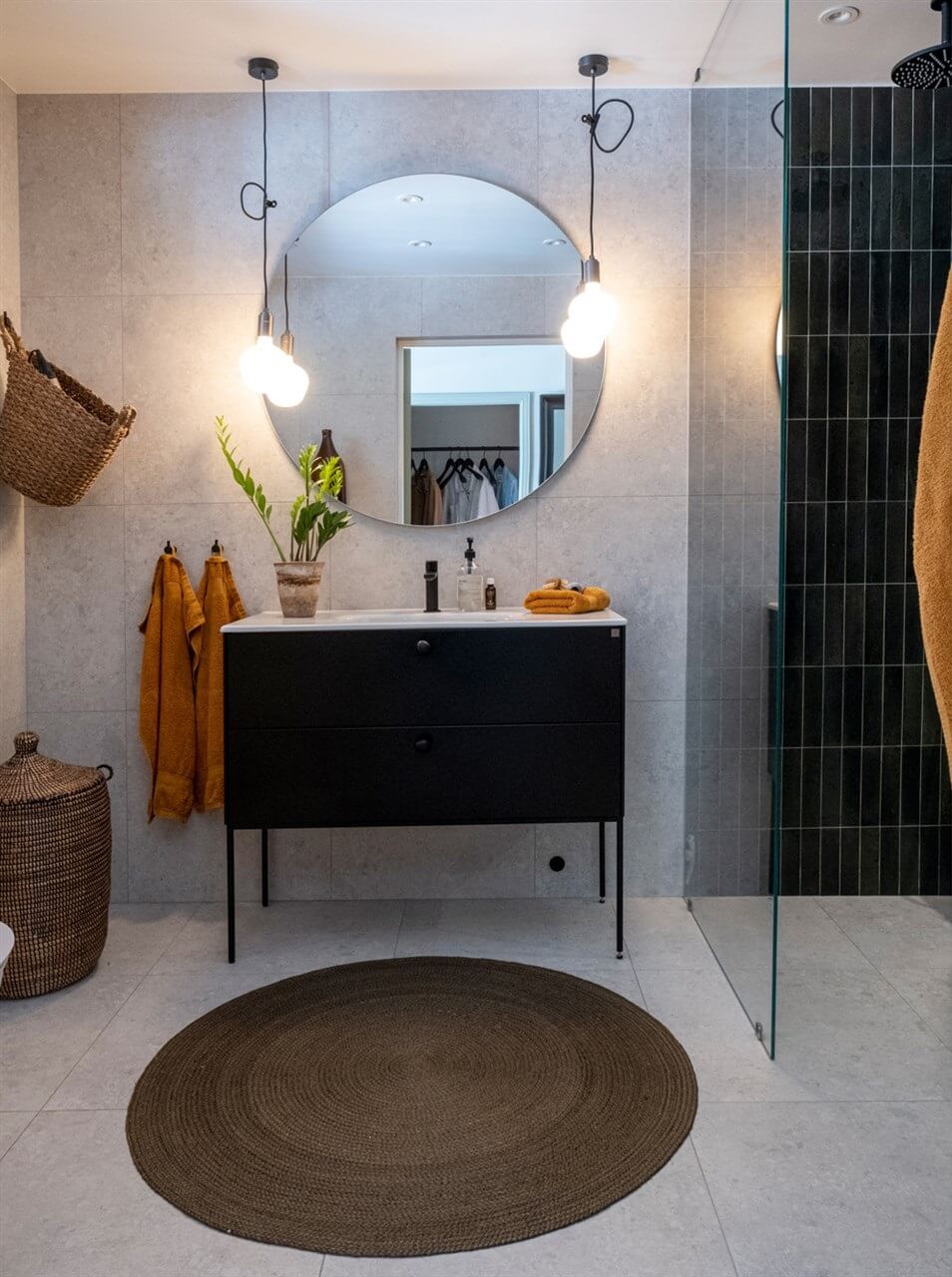 A White Swedish Villa with a Veranda and a Swimming Pool 23 modern bathroom round mirror and dark green shower tiles nordroom