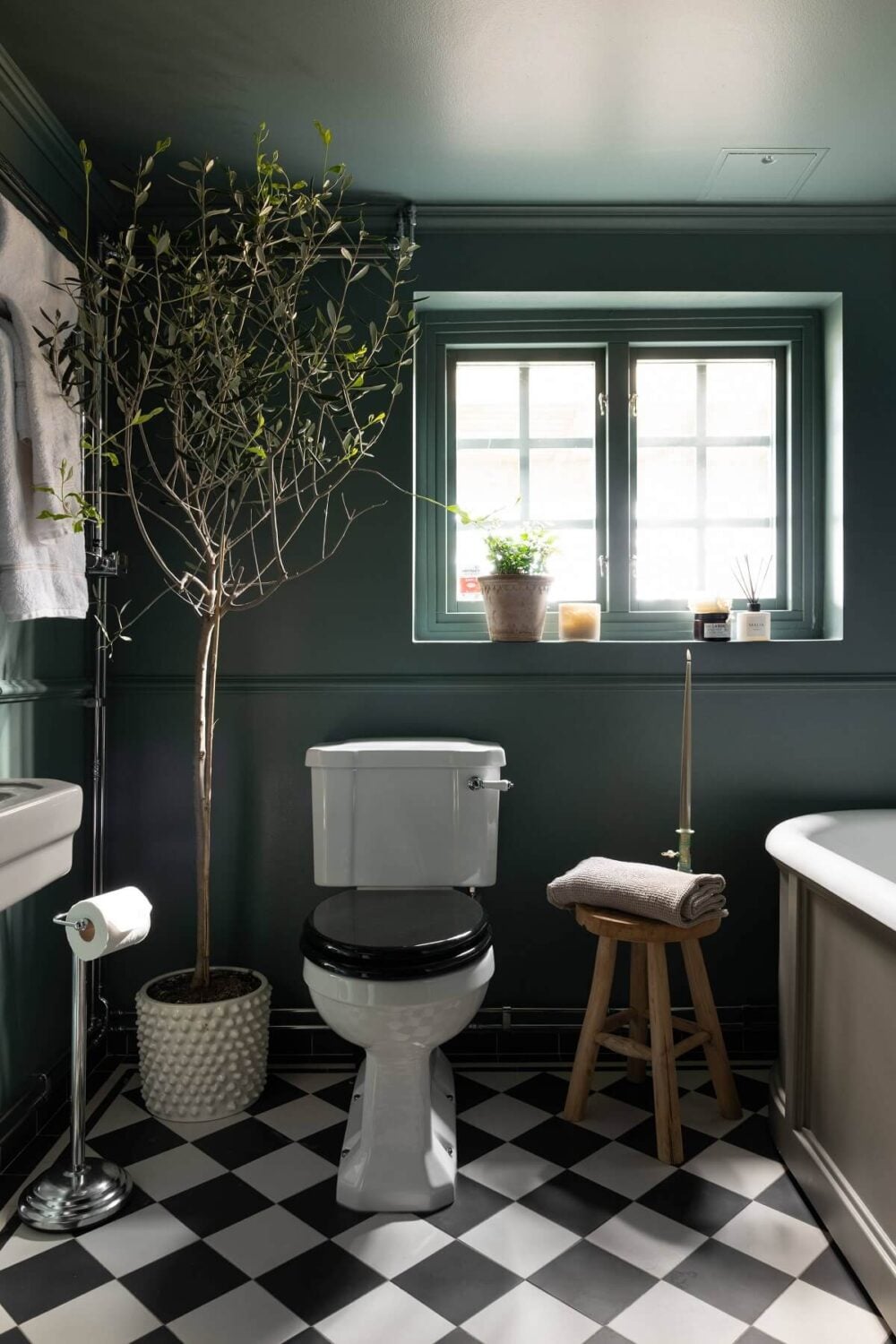 A Yellow Swedish Villa with Views of the Sea 21 moody bathroom with checkerboard floor nordroom