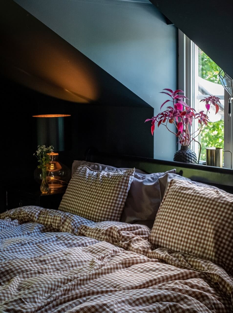 A White Swedish Villa with a Veranda and a Swimming Pool 14 moody dark blue bedroom with slanted ceiling nordroom