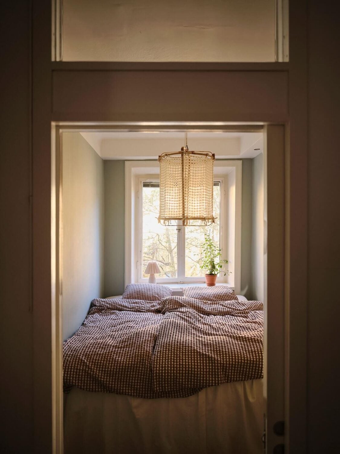 Muted Gray, Green, and Yellow Walls in a Stockholm Apartment 13 narrow bedroom