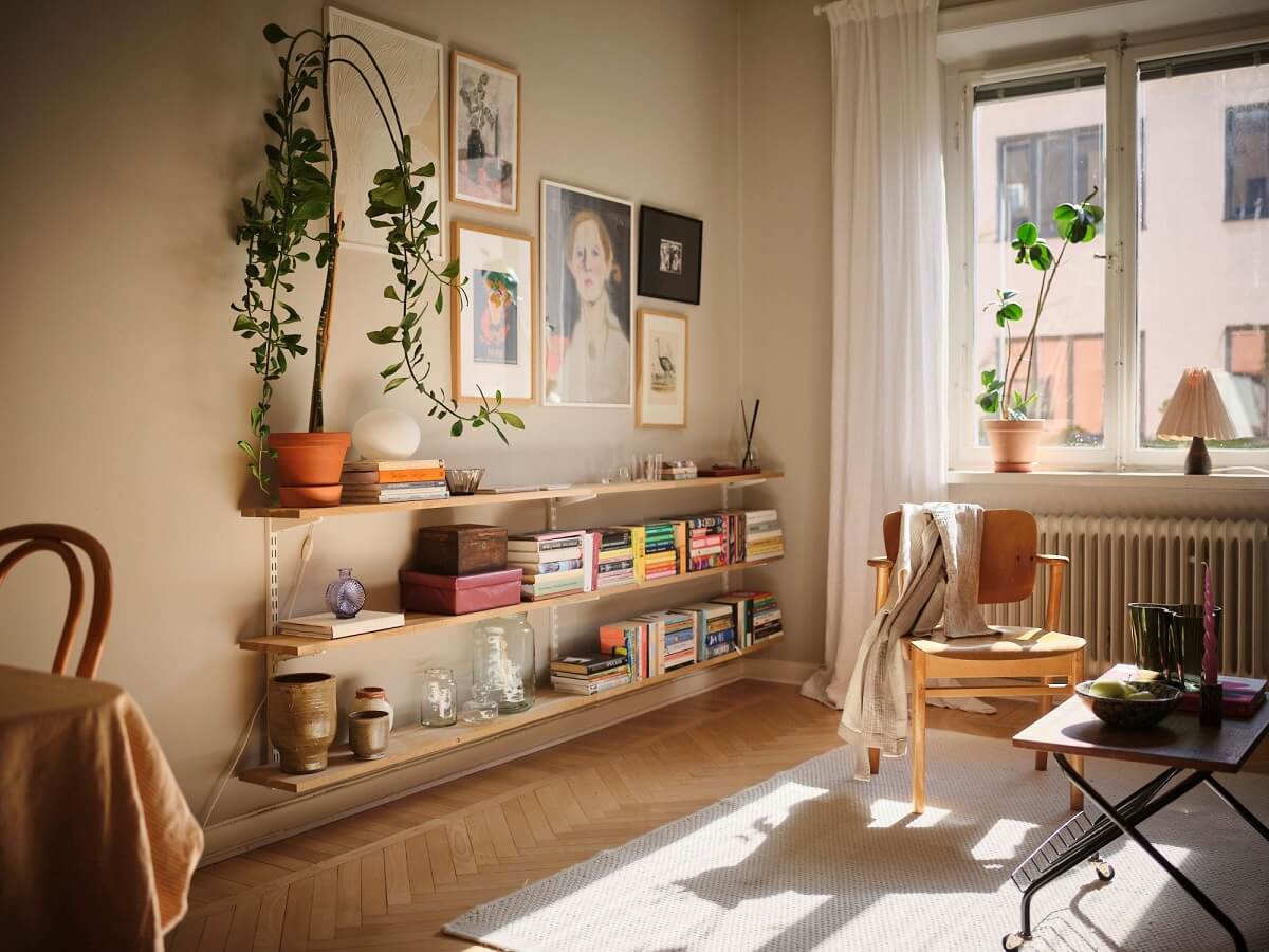 Muted Gray, Green, and Yellow Walls in a Stockholm Apartment 4 natural light gray walls and shelves in living room