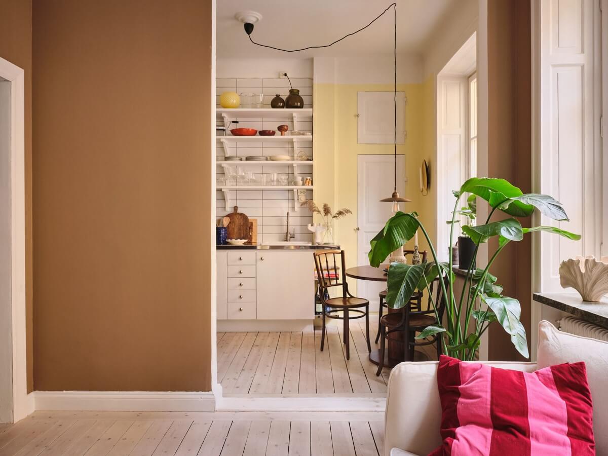 A Small Apartment with Calm Brown, Green, and Yellow Walls 3 open plan living and kitchen with brown and yellow walls nordroom