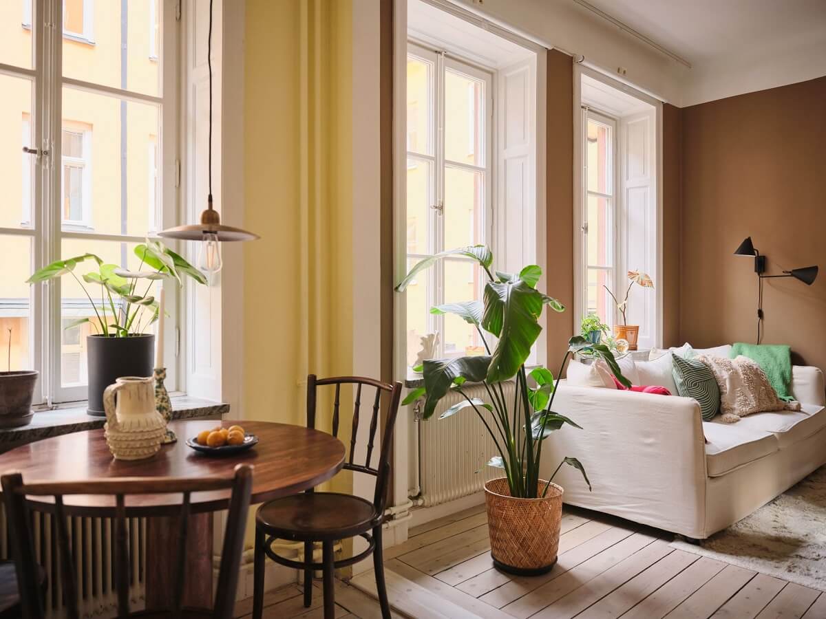 A Small Apartment with Calm Brown, Green, and Yellow Walls 5 open plan living room kitchen with yellow and brown walls nordroom