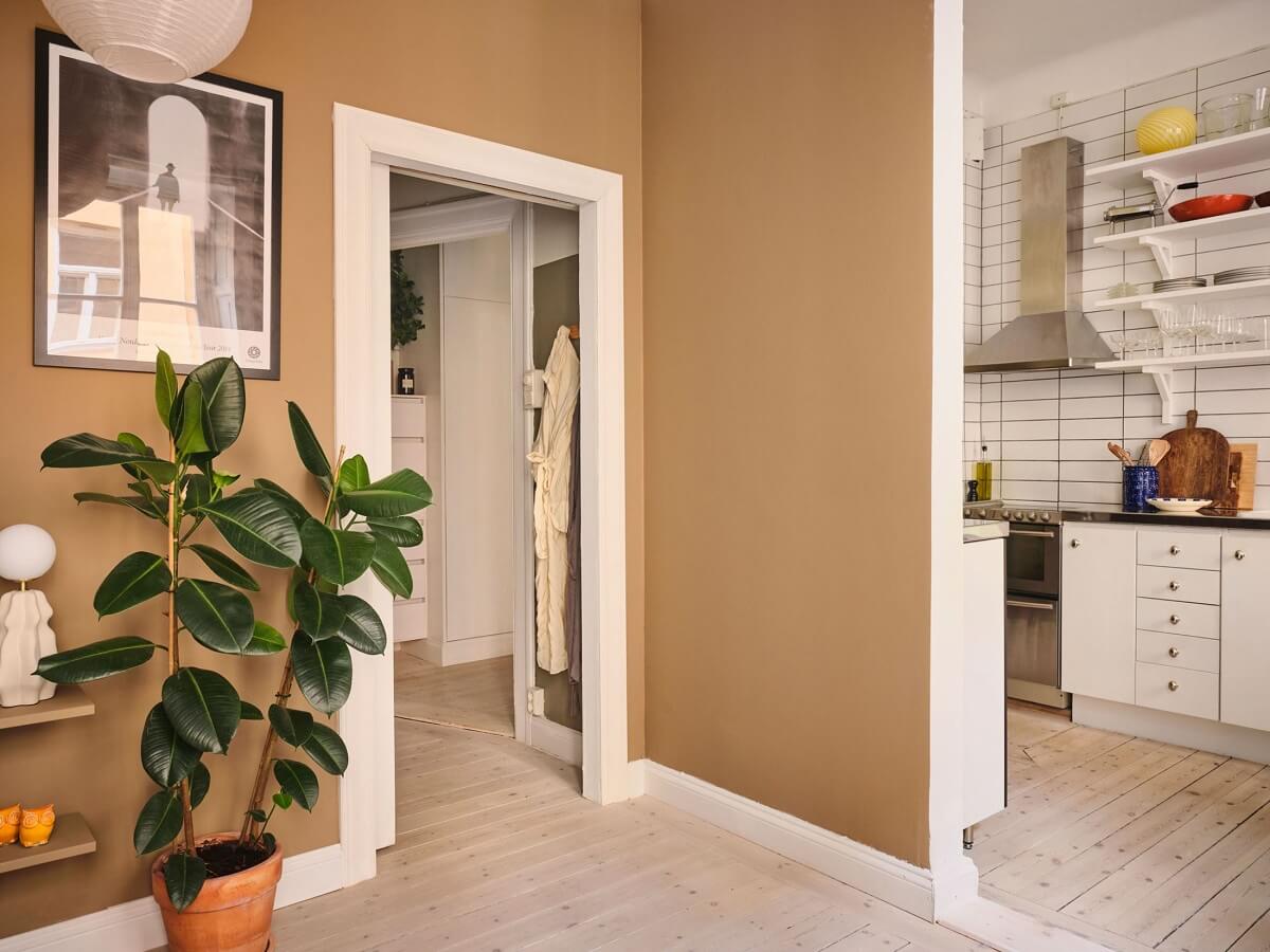 A Small Apartment with Calm Brown, Green, and Yellow Walls 11 open plan living room with light brown walls nordroom