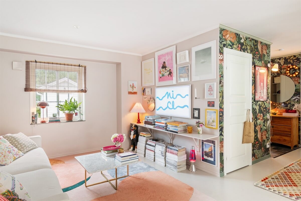 A Bright Open-Plan Swedish Home with a Pink Kitchen 3 pastel colored art and decor in living room