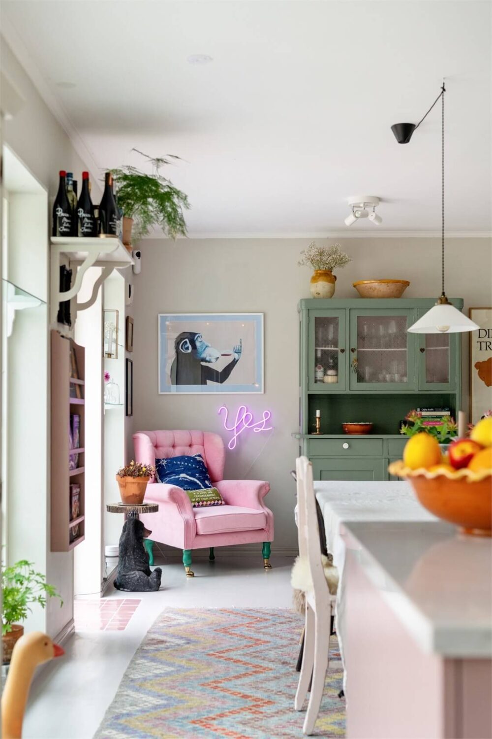 A Bright Open-Plan Swedish Home with a Pink Kitchen 15 pink chair in kitchen