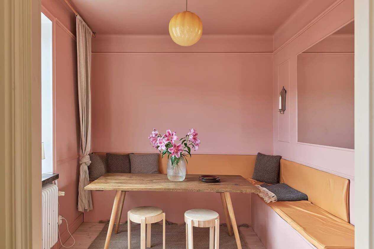 Warm Color-Drenched Rooms in a Swedish Apartment 13 pink dining room with built in bench