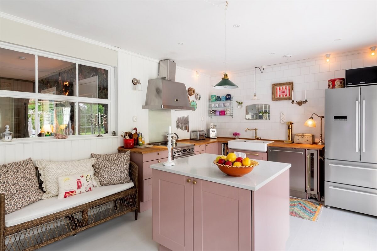 A Bright Open-Plan Swedish Home with a Pink Kitchen 9 pink kitchen with bench seating