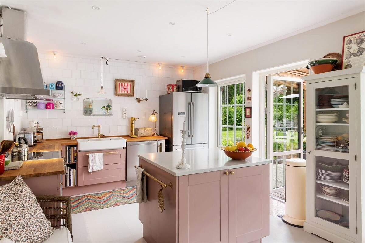 A Bright Open-Plan Swedish Home with a Pink Kitchen 10 pink kitchen with island