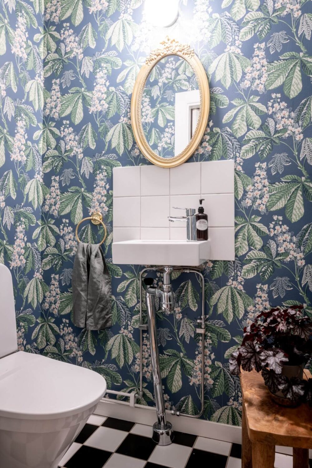 A Scandinavian Apartment with a Pale Yellow Living Room 23 powder room with blue wallpaper