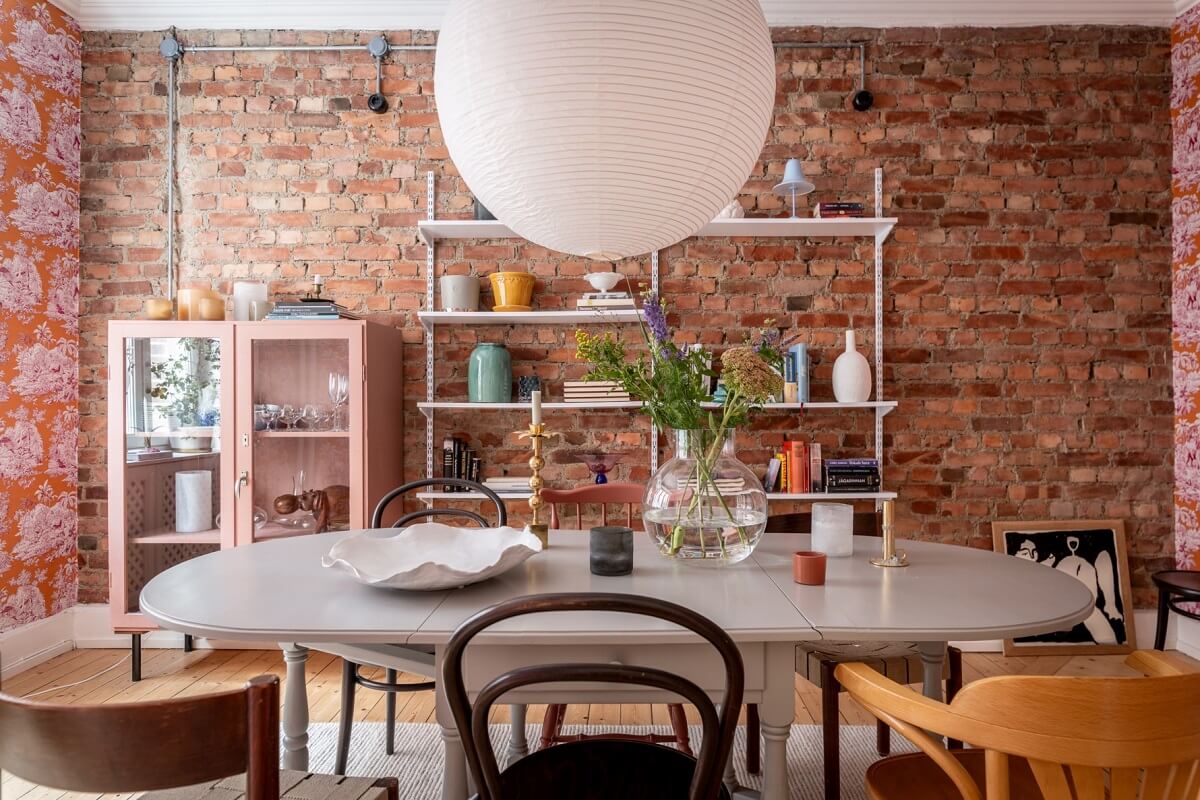 A Scandinavian Apartment with a Pale Yellow Living Room 11 raw brick wall dining room
