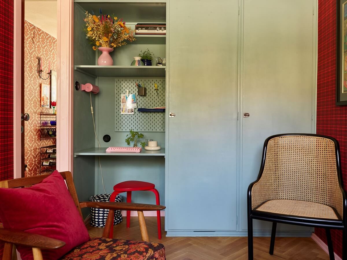 A Colorful Swedish Apartment Inspired by the 50s and 70s 21 room with built in wardrobes and small home office with red stool nordroom