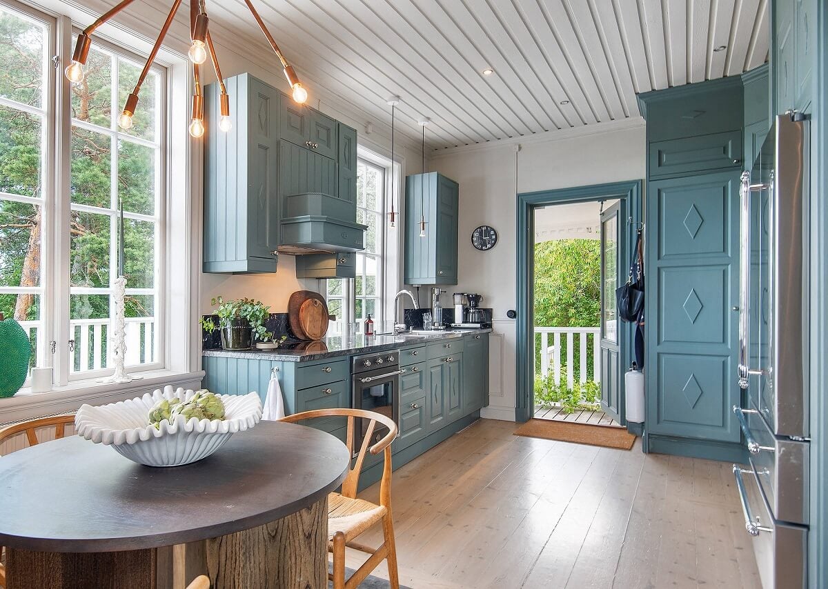 A Yellow Swedish Villa with Views of the Sea 6 round dining table in country kitchen nordroom