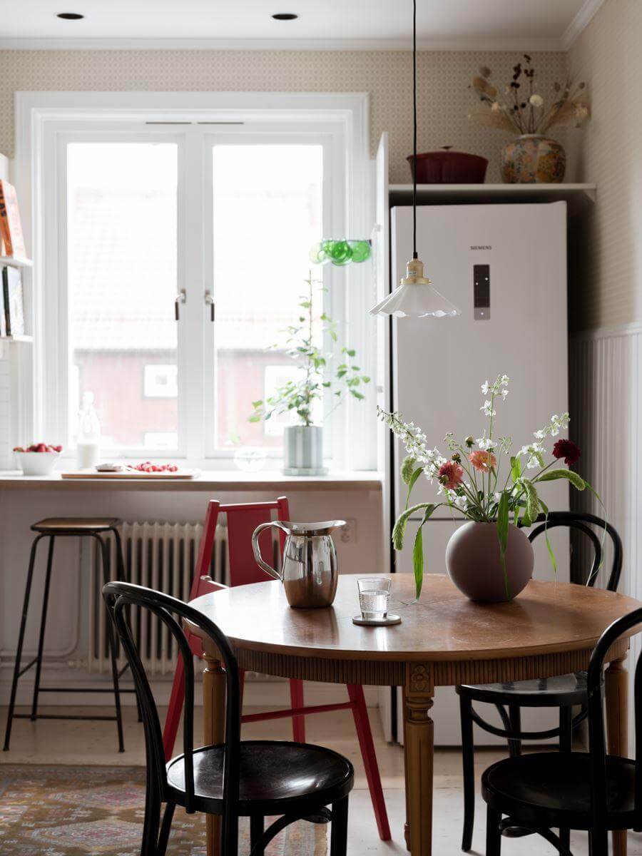 A Beautiful Renovated Maisonette Home with a Calm Color Palette 12 round wooden table in kitchen