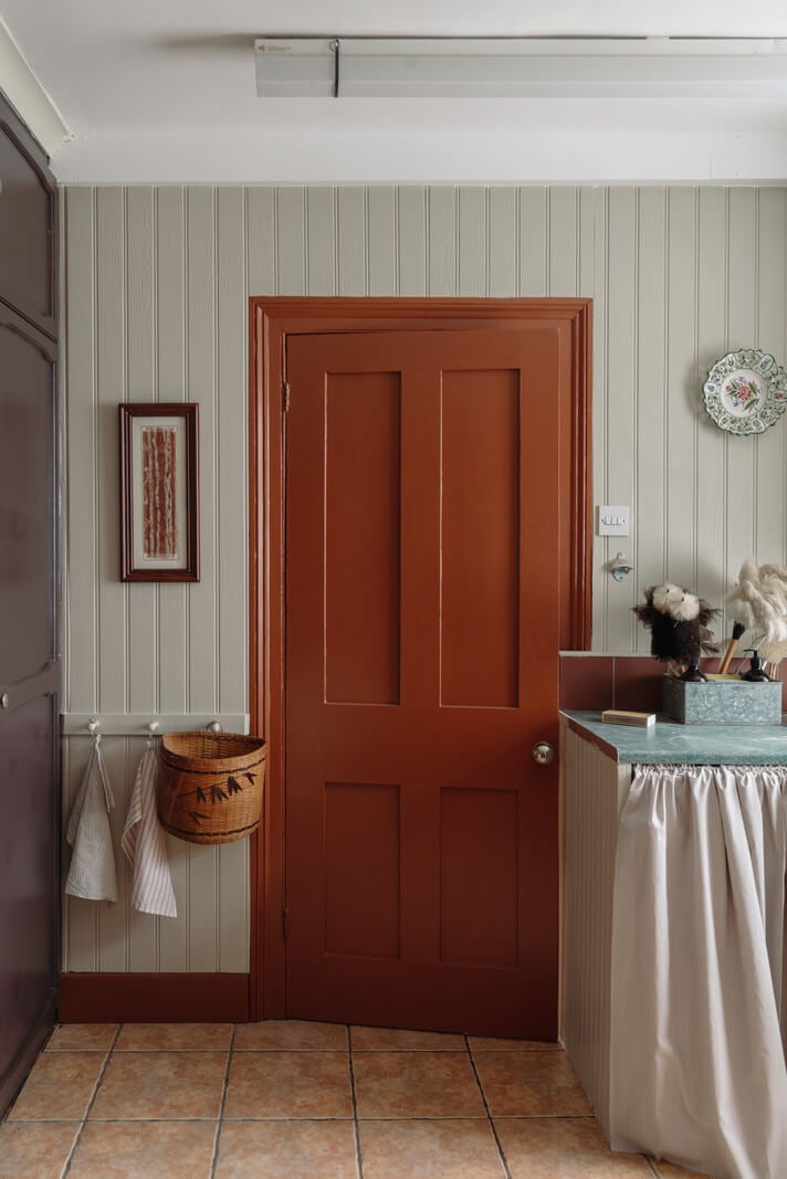 Pared Back Interiors in an English Home in Kent 17 rusty red kitchen door