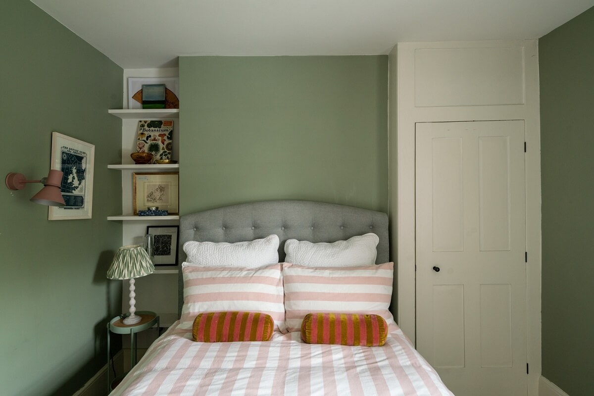A Beautiful London Family Home with Colorful Accents 20 sage green bedroom with built in wardrobe
