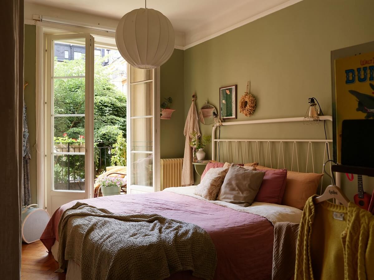 A Cozy 1920s Apartment with Original Details and Wallpaper 18 sage green walls bedroom with baby cot nordroom
