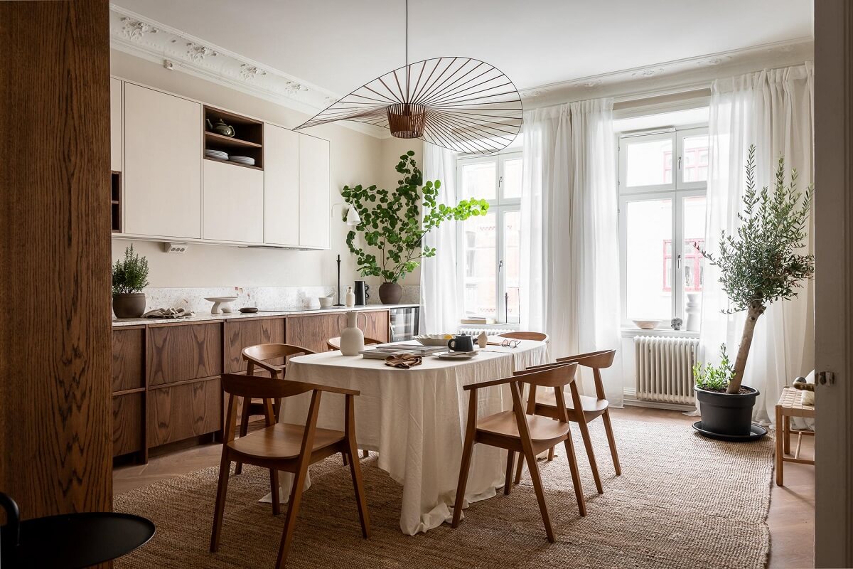 A Spacious Renovated Apartment with a Light Pink Living Room 11 scandinavian kitchen with large dining table nordroom