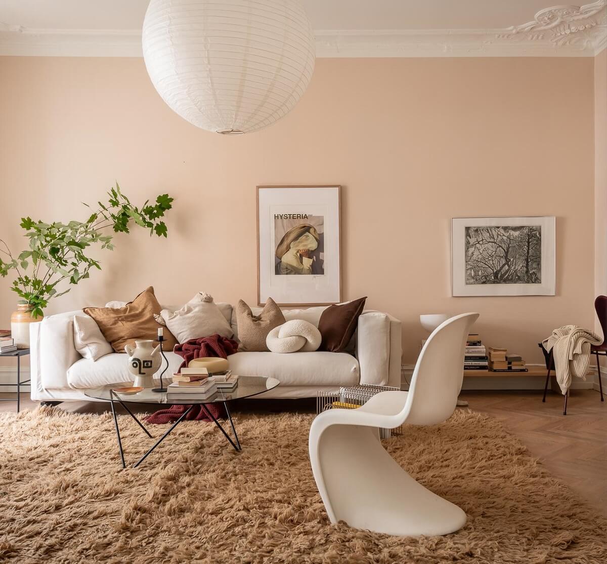 A Spacious Renovated Apartment with a Light Pink Living Room 3 scandinavian living room with light pink walls and large rug nordroom