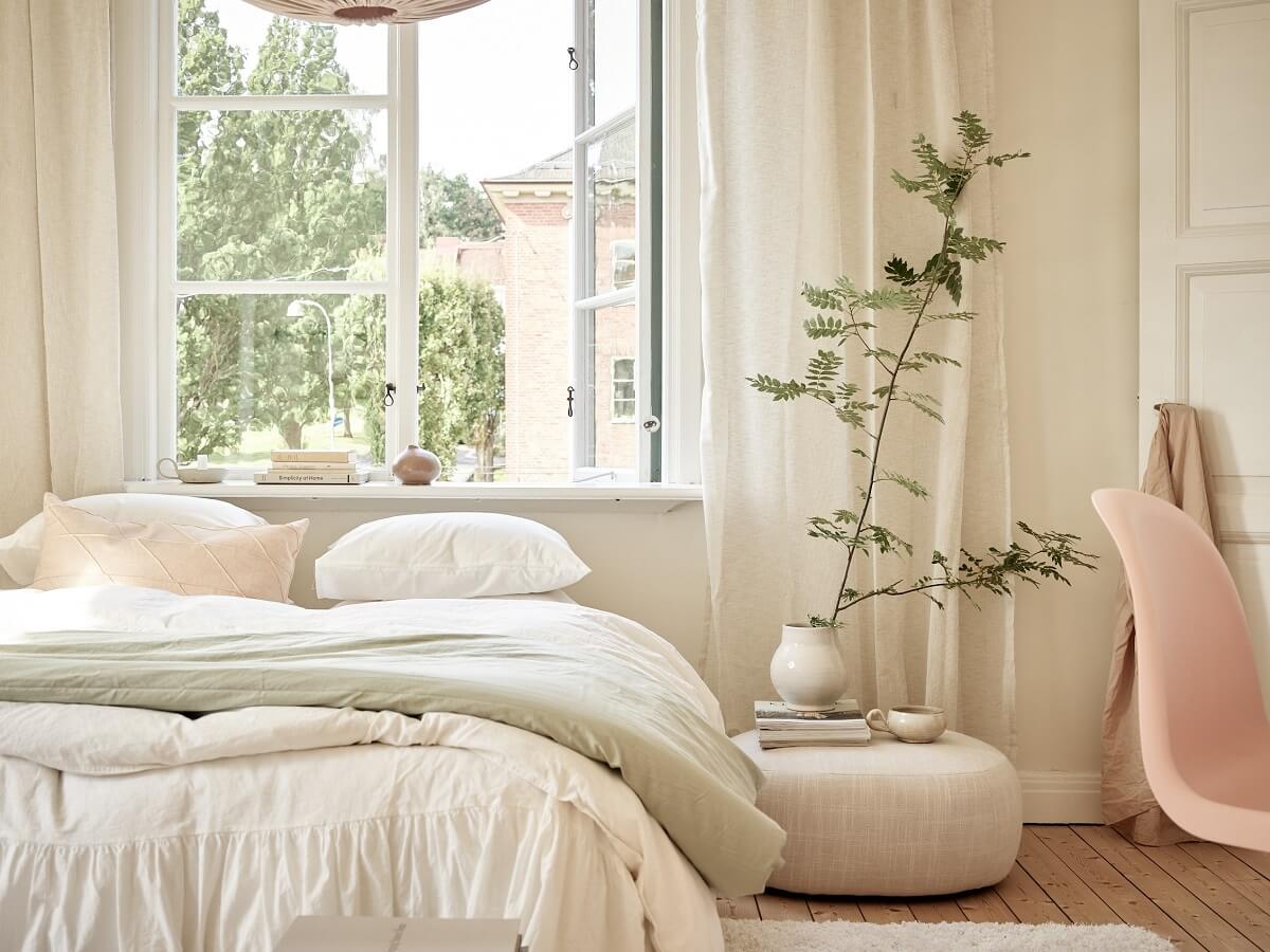 A Light Swedish Apartment with a Charming Kitchen 14 serene bedroom with bed under window