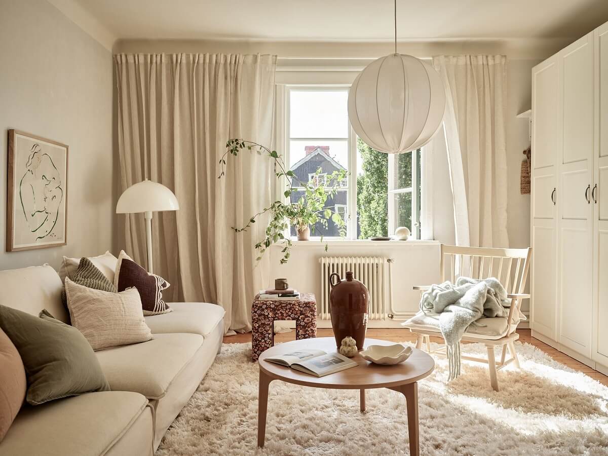 A Light Swedish Apartment with a Charming Kitchen 1 serene living room with large rug