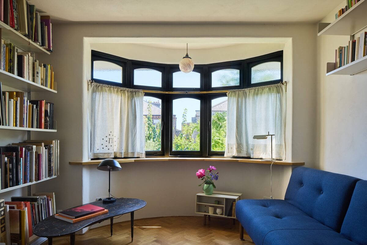 Stained Glass Doors and Terrazzo in a London Home 15 sitting room with blue sofa and shelves