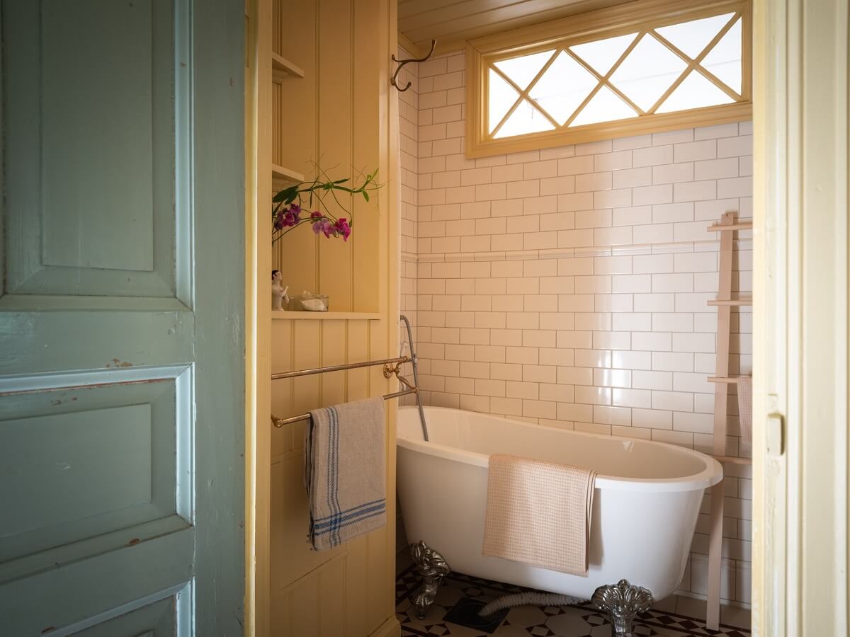 Charming Vintage Country Style in a Family Apartment in Sweden 30 small bathroom with bath and butter yellow walls nordroom