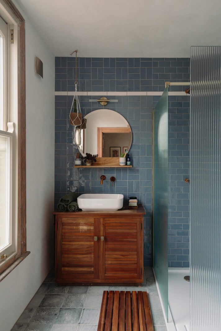 Pared Back Interiors in an English Home in Kent 26 small bathroom with blue tiles and shower