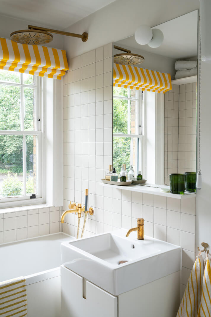 A Beautiful London Family Home with Colorful Accents 24 small bathroom with striped yellow curtain nordroom
