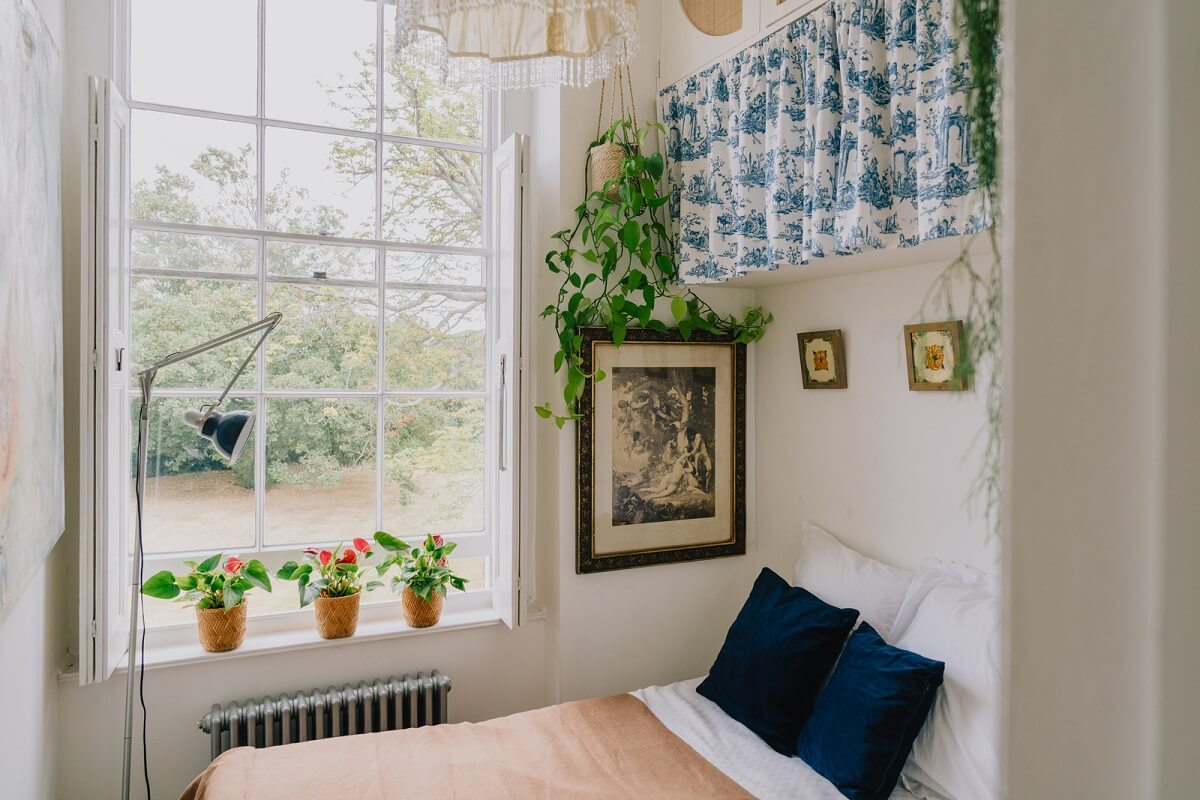 Plants, Art, and a Huge Bay Window in a London Apartment 15 small bedroom with large window and cabinets fronted with curtains nordroom