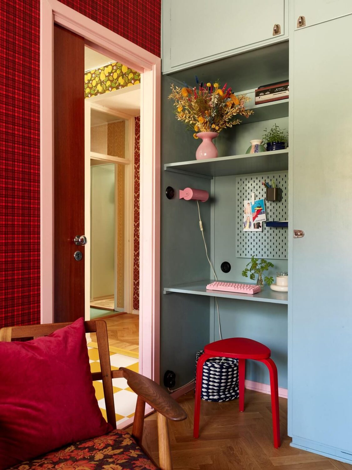A Colorful Swedish Apartment Inspired by the 50s and 70s 22 small light blue built in desk with red stool nordroom