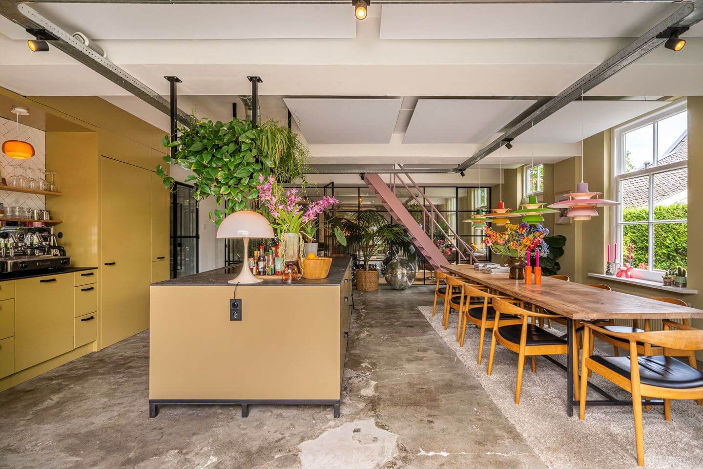 An Old Smokehouse Transformed Into a Modern Industrial Home 9 spacious kitchen yellow cabinets large table industrial floor nordroom