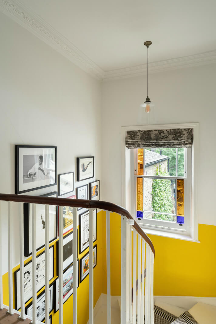 A Beautiful London Family Home with Colorful Accents 16 staircase with half painted yellow wall nordroom