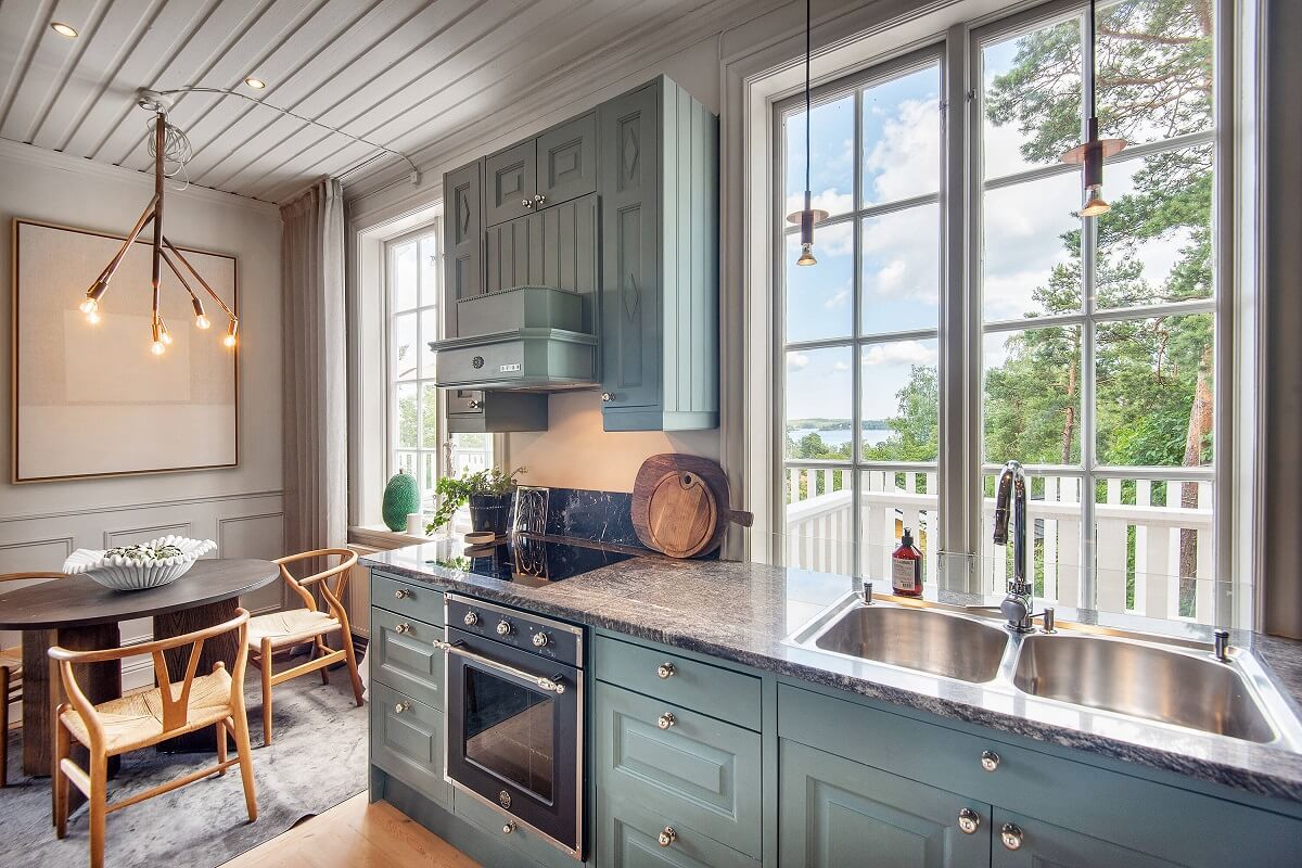 A Yellow Swedish Villa with Views of the Sea 8 swedish country kitchen with round dining table nordroom
