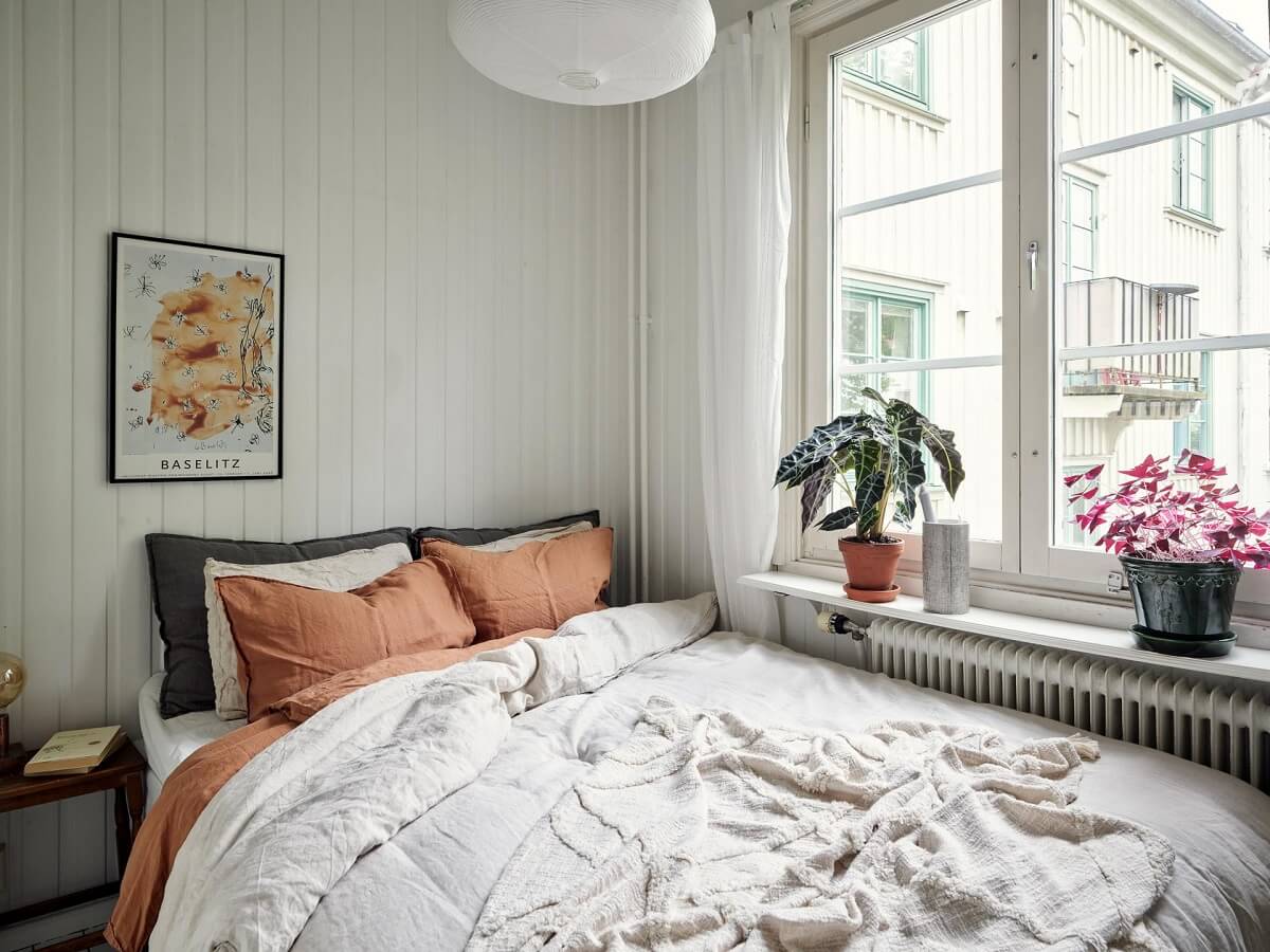 A Small Apartment with a Bright Open-Plan Kitchen & Bedroom 9 tiny bedroom with wood paneled walls