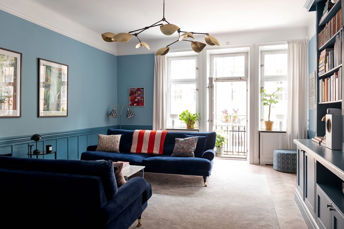 A Classic Apartment with a Blue Living Room 5 two tone blue sitting room with large windows