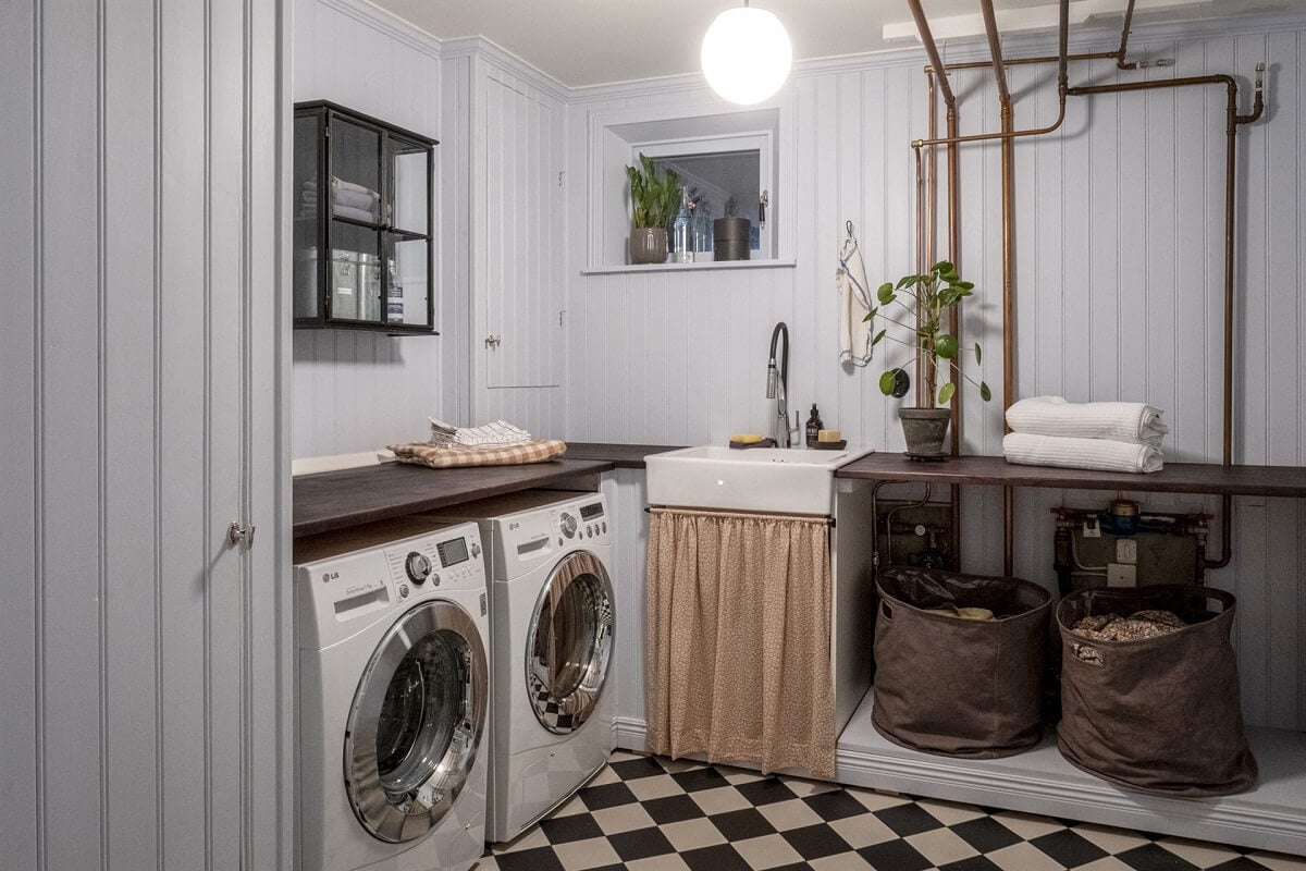 A White Swedish Villa with a Veranda and a Swimming Pool 25 utility room with checkerboard floor