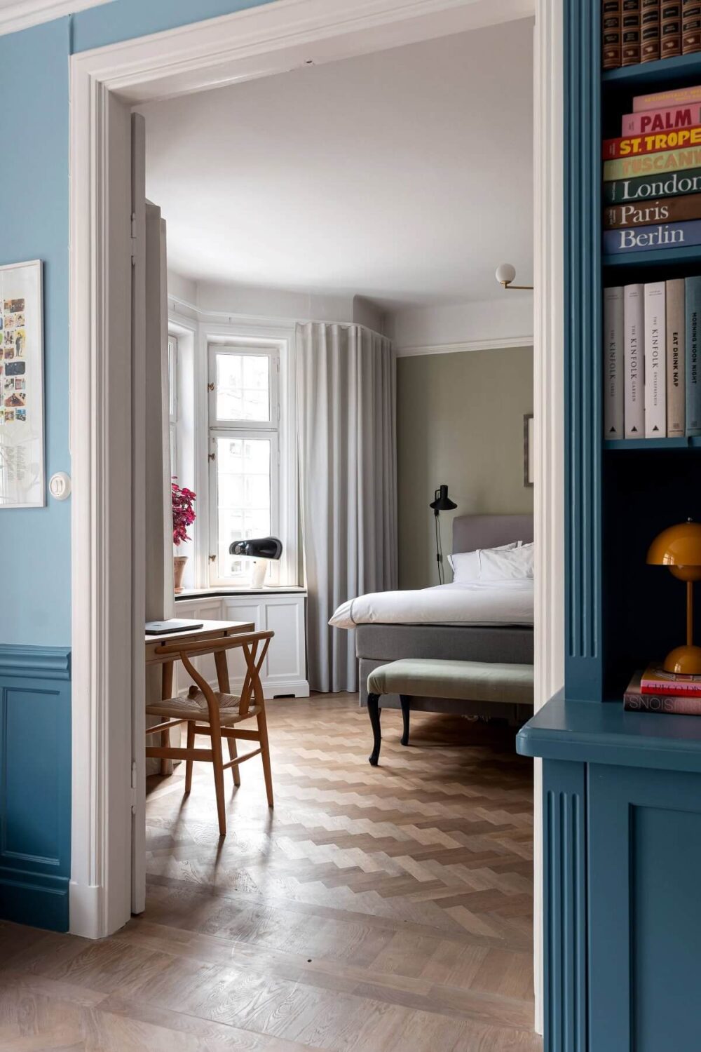 A Classic Apartment with a Blue Living Room 11 view into bedroom