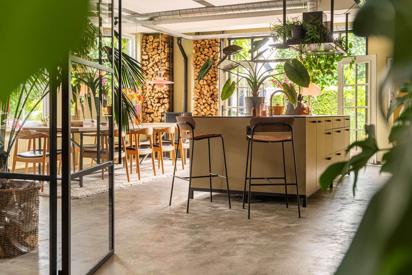 An Old Smokehouse Transformed Into a Modern Industrial Home 8 view into kitchen with island