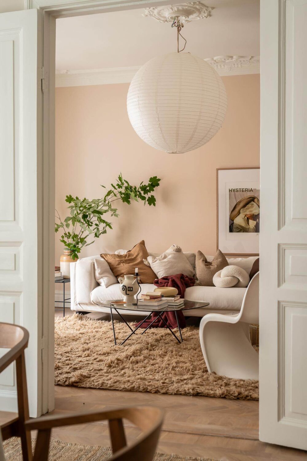 A Spacious Renovated Apartment with a Light Pink Living Room 1 view into living room with beige pink walls